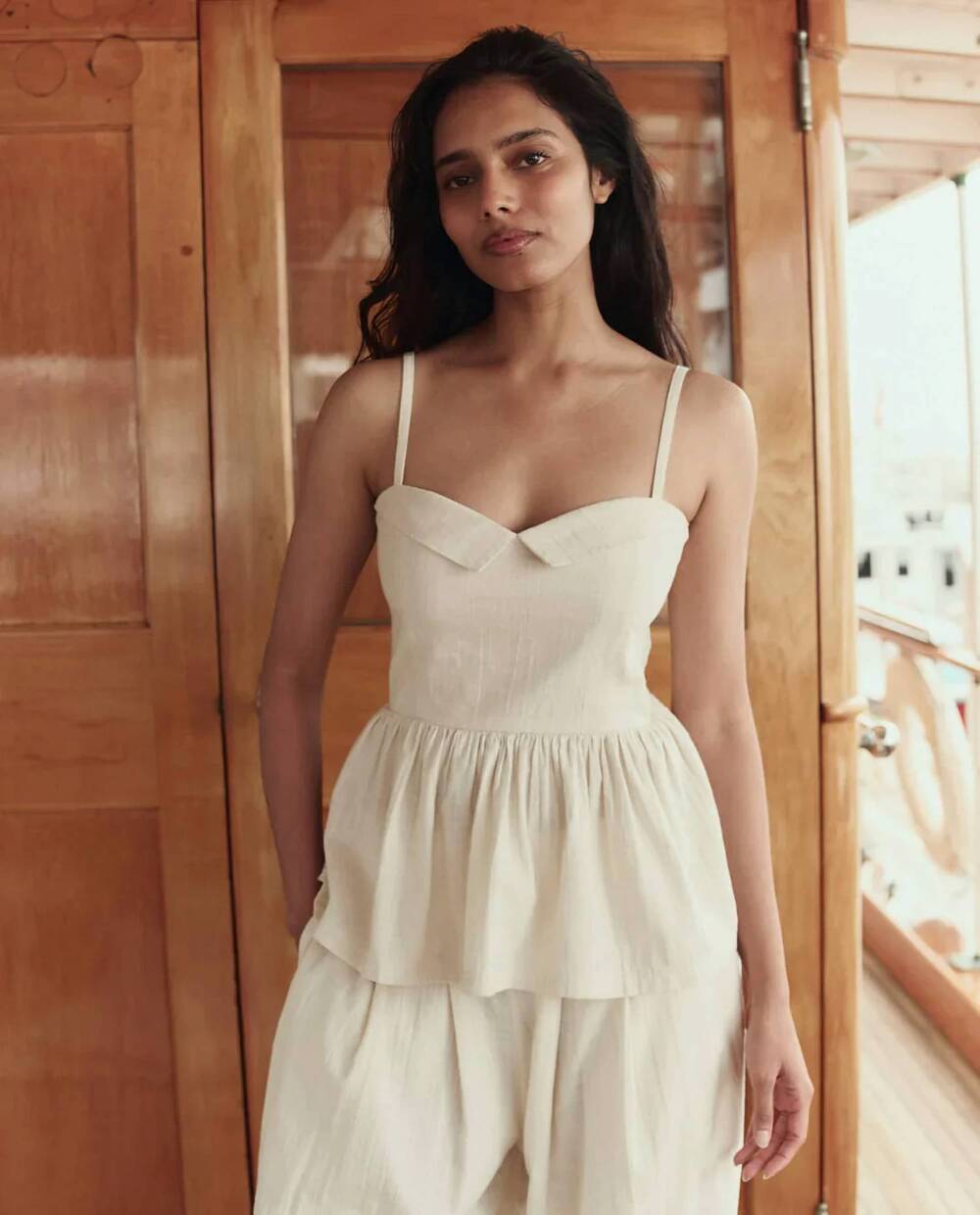 NEW THE GREAT. verse peplum top in natural